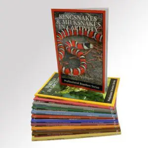 A stack of books with the cover for kingsnakes and milksnakes