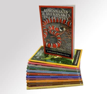 A stack of books with the cover for kingsnakes and milksnakes