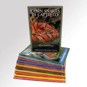A stack of books with a picture of corn snakes on them.
