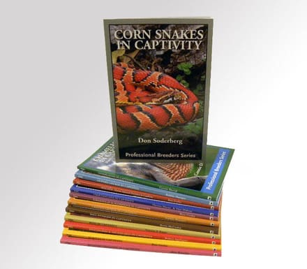 A stack of books with a picture of corn snakes on them.