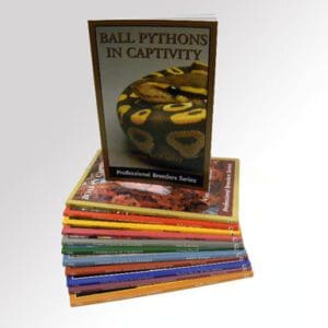 A stack of books with the cover of ball python in captivity.