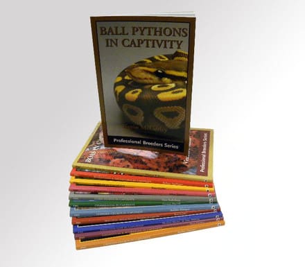 A stack of books with the cover of ball python in captivity.