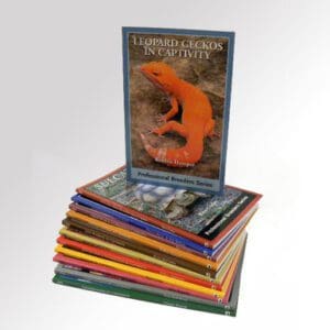A stack of books with an image of a lizard on the cover.