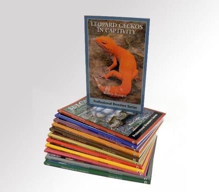 A stack of books with an image of a lizard on the cover.