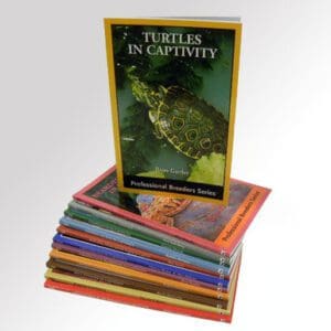 A stack of books with turtles in captivity on them.