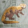 A close up of the embroidered animal on a hat