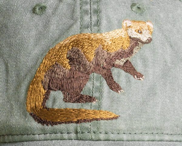 A close up of the embroidered animal on a hat