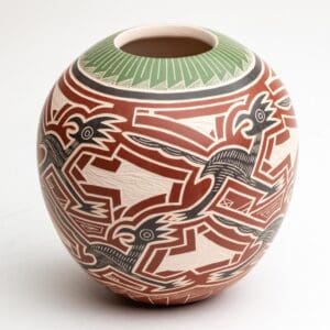 A vase with red, white and green designs on it.