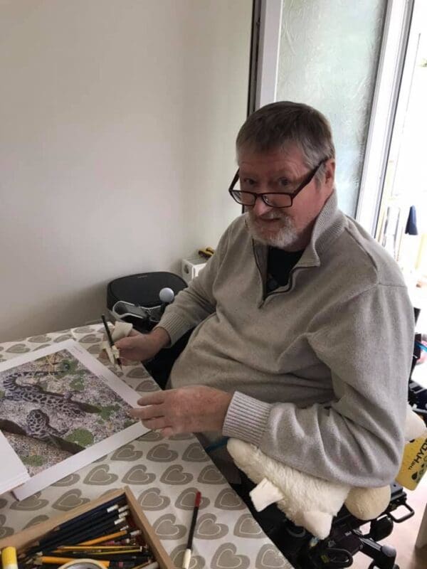 A man sitting at a table with papers in front of him.