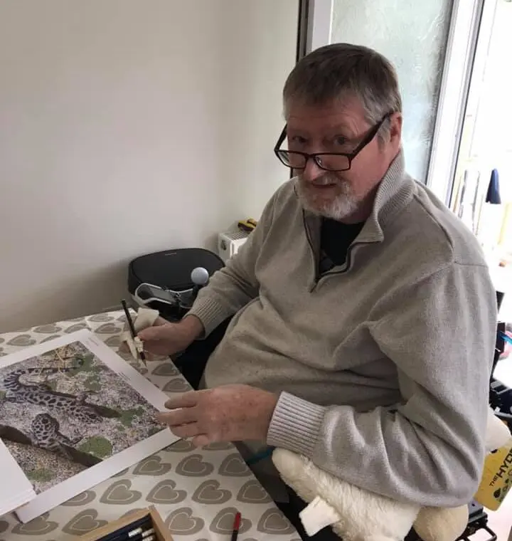 A man sitting at a table with papers in front of him.