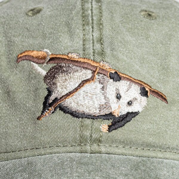 A baseball cap with an animal on it.