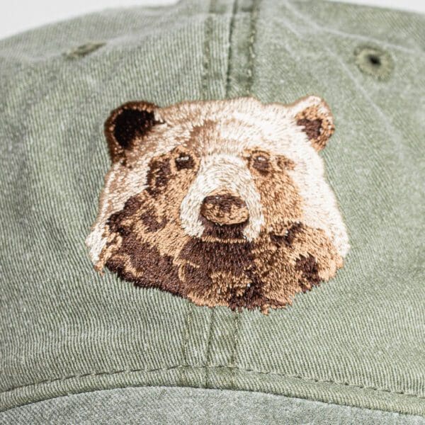 A close up of the bear 's face on a hat