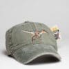 A hat with an embroidered dinosaur on it.