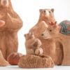 A group of bears that are sitting on the ground.