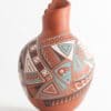 A vase with an artistic design on it.