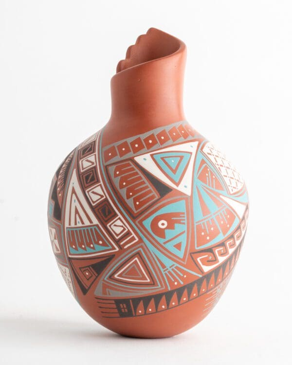 A vase with an artistic design on it.