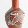 A close up of the side of an artistic vase