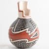 A vase with a red and white design on it.