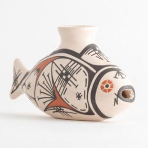 A ceramic fish vase with black, white and orange designs.