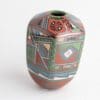 A colorful vase with geometric designs on it.