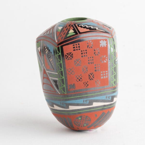 A colorful vase with geometric designs on it.