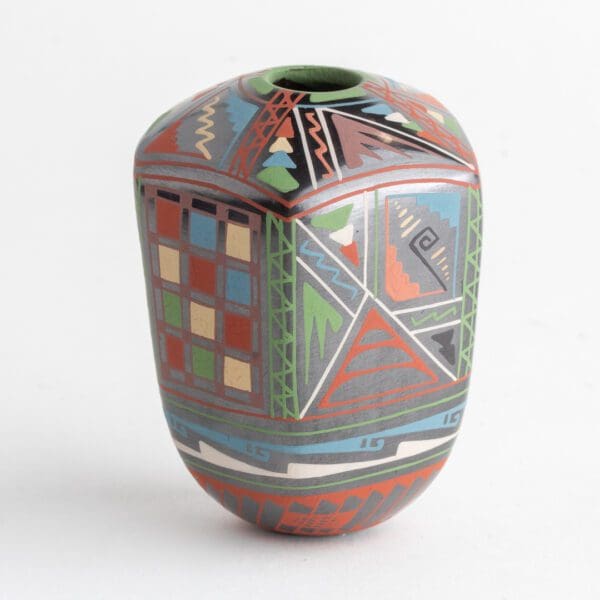 A colorful vase with geometric designs on it.