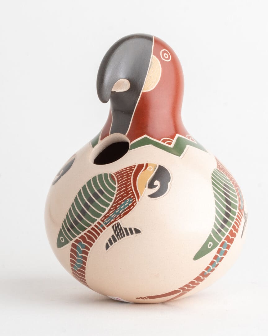 A bird shaped vase with a colorful design on it.