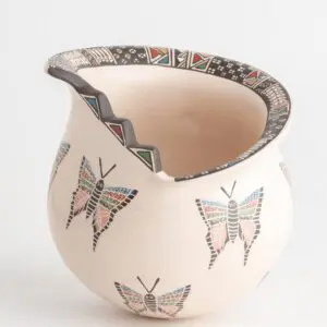 A white vase with butterflies on it.