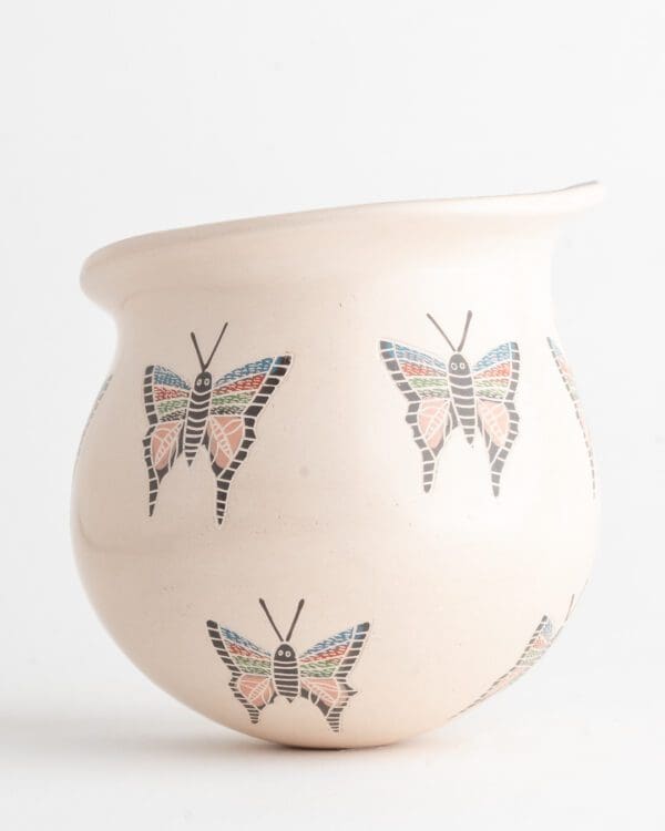 A white vase with butterflies on it.