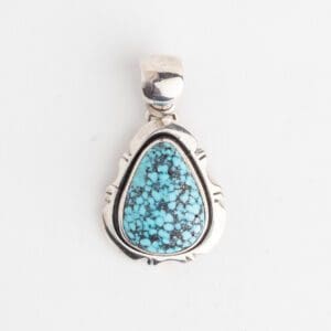 A silver pendant with blue stone on it.