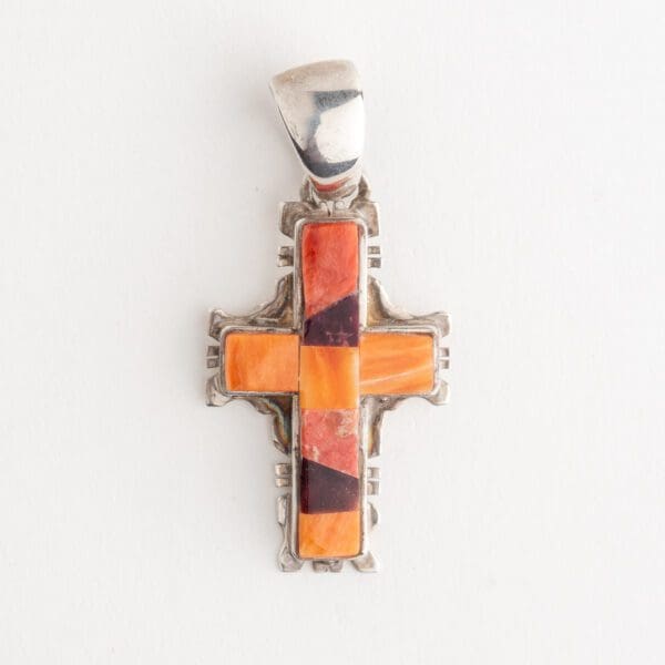 A cross is shown with orange and brown colors.