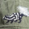 A close up of the back of a hat with an animal on it