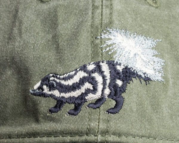 A close up of the back of a hat with an animal on it