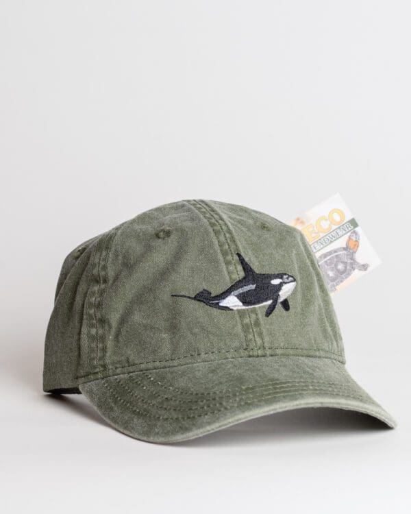 A hat with an orca on it is shown.