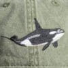 A close up of the orca whale on a hat