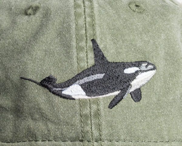 A close up of the orca whale on a hat