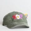 A green hat with flowers on it.