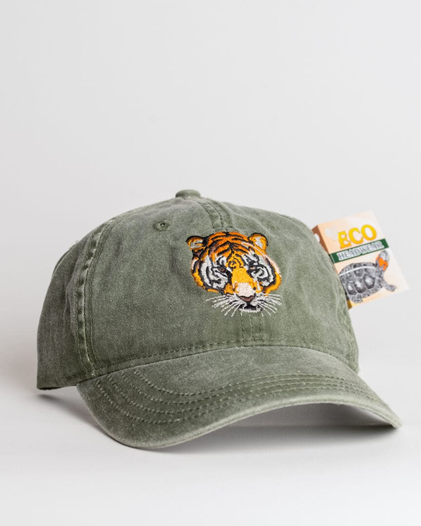 A green hat with an embroidered tiger on it.