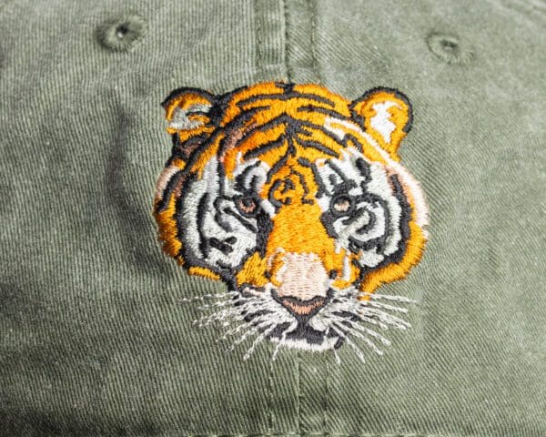 A close up of the tiger 's face on a hat