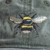 A close up of the bee on a hat