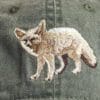 A close up of the embroidered fox on a hat