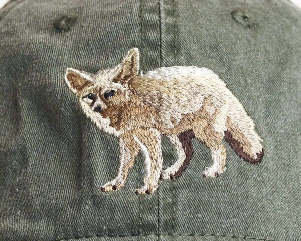 A close up of the embroidered fox on a hat