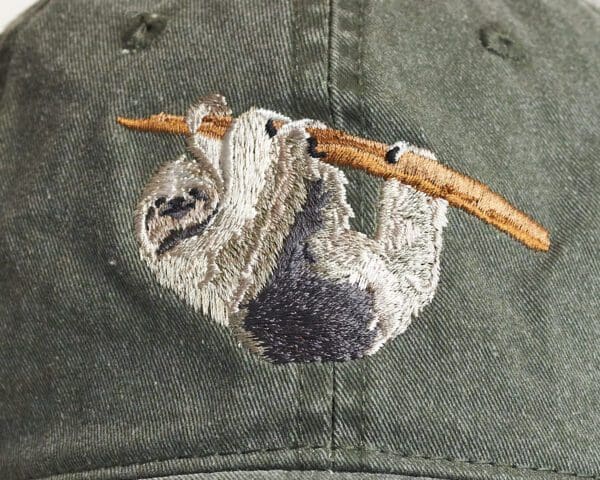 A close up of the back of a hat with a sloth on it