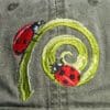 A close up of the ladybug on a hat