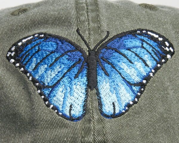 A close up of the back of a hat with a butterfly on it